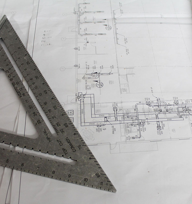 Carpenter's speed square and blueprints