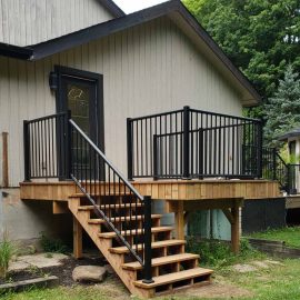 Whitfield Home Improvements: new wooden deck and stairs with metal railing