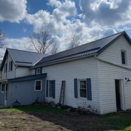 Exterior renovation including steel roof and trim by Whitfield Home Improvements