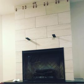 Whitfield Home Improvements - tiling a new gas fireplace with hearth and mantle