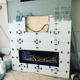 Whitfield Home Improvements - tiling a new gas fireplace and entertainment center