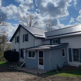 Exterior renovation including steel roof and trim by Whitfield Home Improvements