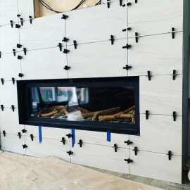 Whitfield Home Improvements - tiling a new gas fireplace and entertainment center