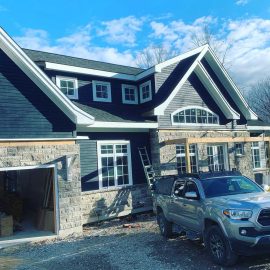 Whitfield Home Improvements - new home construction - double car garage, shiplap siding and stone facade