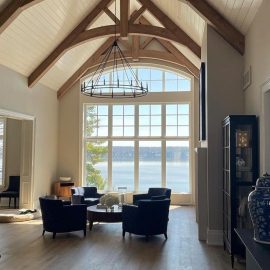 Beautiful vaulted ceiling with large glass windows overlooking the lake.